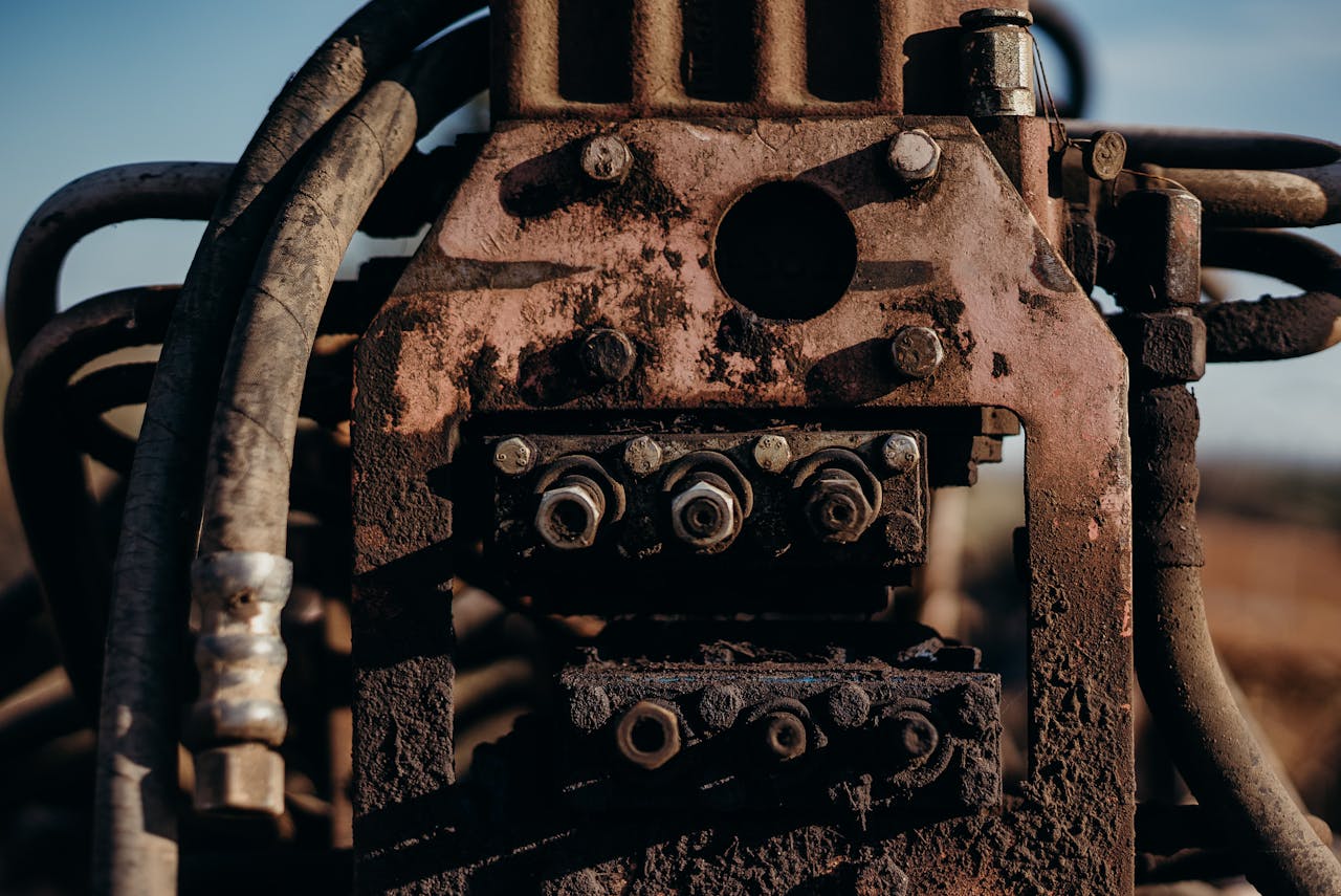 services-09 A detailed view of rusted industrial machinery parts, embodying age and durability.