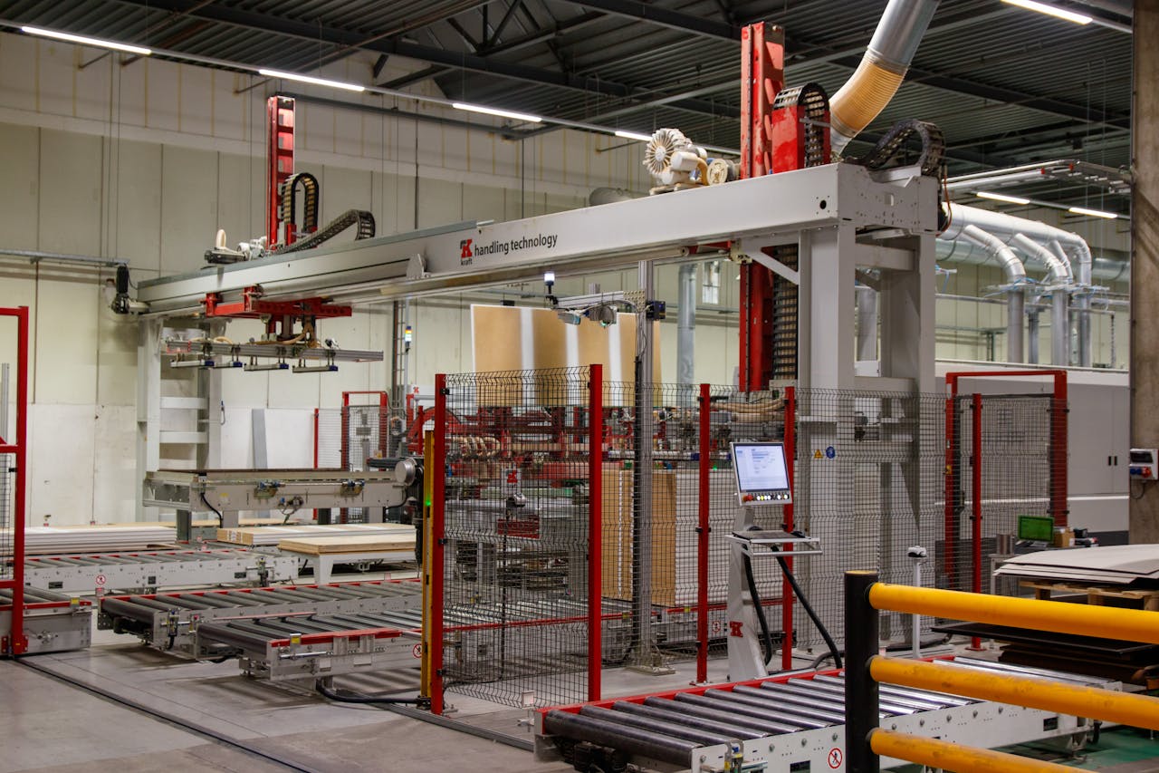 about-02 Industrial machinery with robotic arm in a modern manufacturing facility.